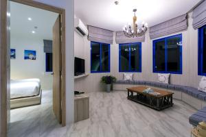 a living room with a bed and a couch and a table at Costa Village Bangsaray in Bang Sare