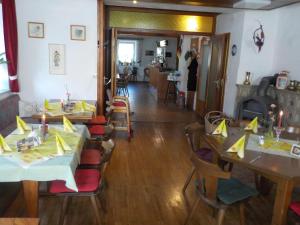 a dining room with two tables and a fireplace at Zehrermühle Campinghütte in Schönberg