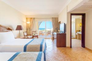 a hotel room with two beds and a balcony at Kempinski Hotel Soma Bay in Hurghada