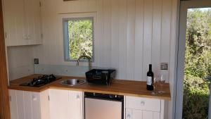 a kitchen with a sink and a counter with a bottle of wine at The Wheelhouse in Bude