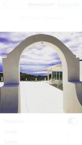 an archway leading to a building with the ocean at Casamediterranea in Sperlonga