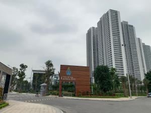 a sign in front of some tall buildings at A Cosy Apartment in Vinhomes Green Bay Ha Noi in Hanoi