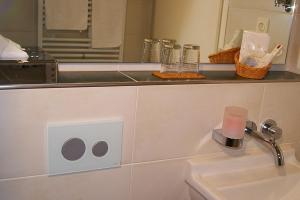 a bathroom with a sink and a counter with a mirror at Hotel Seethaler in Straubing