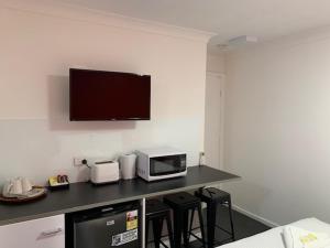 a kitchen with a microwave and a coffee maker at Huskisson Beach Resort in Huskisson