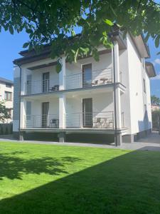 a building with a lawn in front of it at Willa Kormoran in Augustów