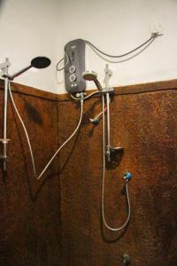 a shower with a blow dryer attached to a wall at Amba Sewana Homestay in Sigiriya