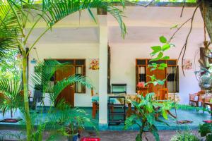 a house with a lot of plants in front of it at Amba Sewana Homestay in Sigiriya