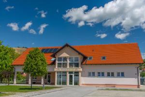 a building with an orange roof at Apartma Murania in Lendava