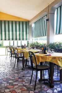 una fila di tavoli e sedie in un ristorante di Albergo La Rovere a Roverbella