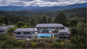 an aerial view of a house with a swimming pool at Collection Luxury Accomodation Simola House in Knysna
