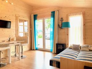 a bedroom with a bed and a table and a desk at Osada Familia in Sarbinowo