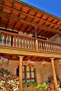 a wooden deck with potted plants on a building at La Cabada in Ortiguero