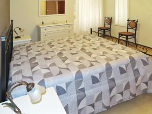 a bedroom with a large bed with two chairs at Casa Vacanze Donna Lucia in Scoglitti