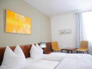 Postel nebo postele na pokoji v ubytování Stadthaus Valentin