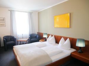 Postel nebo postele na pokoji v ubytování Stadthaus Valentin