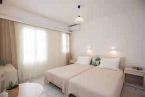 Postel nebo postele na pokoji v ubytování Hotel Charissi