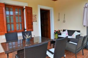 a dining room with a table and chairs at Ithaki House in Vathi +8 photos