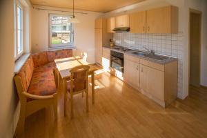 a kitchen with a table and a dining room at Ferienhaus Regina in Walkertshofen