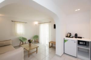 a living room with a couch and a table at Hotel Charissi in Mikonos