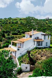 a white house on top of a hill at Villa Von Sophia in Petriaí