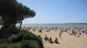 a large group of people sitting on a beach at La Rochelle sur L'eau in La Rochelle