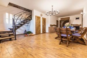 a dining room with a table and chairs and a staircase at Vinařství Fiamoli in Vracov