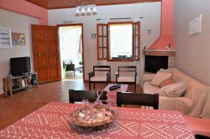 a living room with a table and a couch at Ithaki House in Vathi