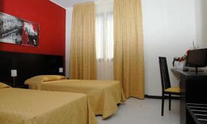 a hotel room with two beds and a television at Hotel Del Brembo in Osio Sotto +5 photos