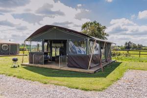 a gazebo in a field of grass at Mousley House Farm Campsite and Glamping in Warwick