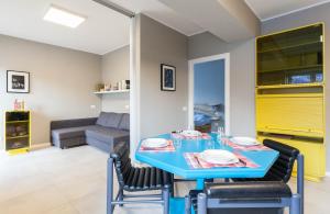a dining room with a blue table and chairs at Appartamento Stelvio in Morbegno +5 photos