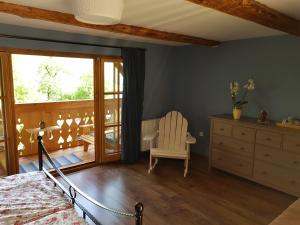 a bedroom with a bed and a chair and a window at pr' Drašlerju in Dovje