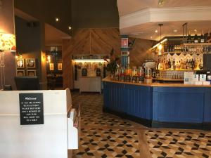 a bar with a blue counter in a restaurant at Waterside by Greene King Inns in Warrington +15 photos