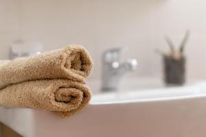 a towel sitting on the edge of a bathroom sink at George's House in Zákros