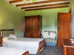 a bedroom with two beds and a chair at Holiday Home Camino La Candelaria-1 by Interhome in La Orotava