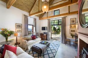 a living room with a couch and a fireplace at Bartinney Private Cellar Banhoek in Stellenbosch