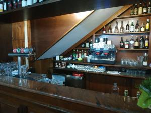 a bar with a lot of bottles on it at Albergo Antica Lanterna in Castelnuovo di Garfagnana