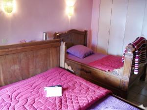 two twin beds in a room with pink sheets at Holiday Home Du Brun by Interhome in Bésignan +23 photos