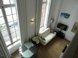 a living room with a couch and a table at ORATORIENS HENRI IV in Dieppe