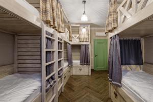 two bunk beds in a room with a green door at Bon Son Hotel and Hostel Центр in Voronezh