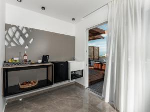 a kitchen with a view of a balcony at Lymberia Hotel in Faliraki