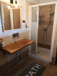 a bathroom with a shower with a wooden counter and a sink at Solmar, Apartment with big terrace near nature in Portorož +43 photos