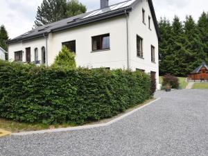 a white house with a hedge in front of it at Quaint Apartment in Vielsalm with Private Terrace in Vielsalm