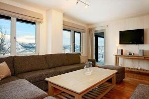 a living room with a couch and a table at Skarsnuten Apartments in Hemsedal