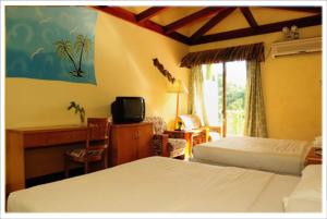เตียงในห้องที่ Airai Water Paradise Hotel & Spa