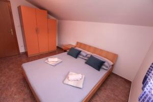 a bedroom with a large bed with two pillows at Apartments Ezra in Gradac