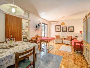 a living room with a table and chairs at Apartment Iris Croatica by Interhome in Veruda