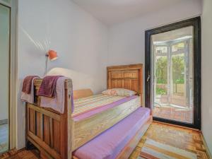 a bedroom with a wooden bed and a window at Apartment Iris Croatica by Interhome in Veruda