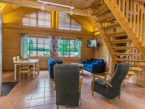 a living room with a staircase and a table and chairs at Holiday Home Juhala by Interhome in Kilvakkala