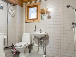 a bathroom with a toilet and a sink at Holiday Home Riekonmarja by Interhome in Äkäslompolo