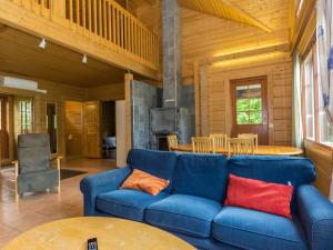 a living room with a blue couch and a table at Holiday Home Juhala by Interhome in Kilvakkala